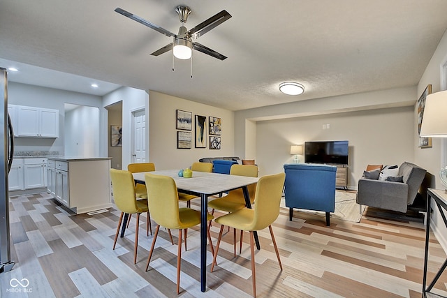 dining area with ceiling fan and light hardwood / wood-style floors