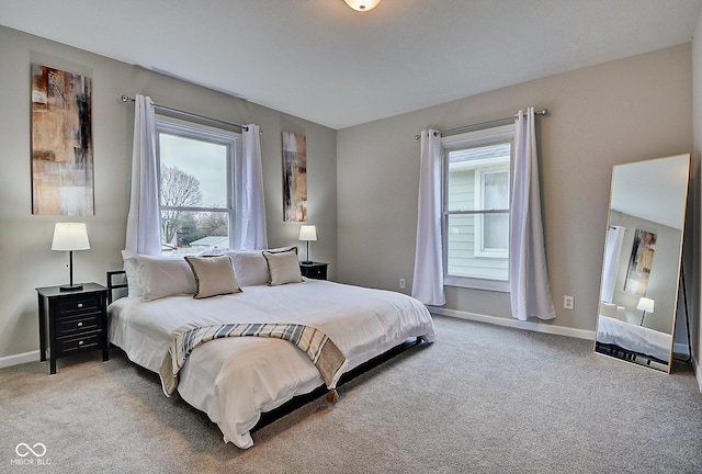 bedroom with multiple windows and carpet flooring