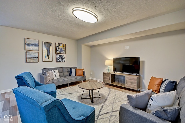 living room featuring hardwood / wood-style flooring and a textured ceiling