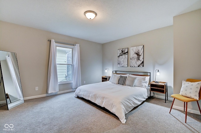 carpeted bedroom featuring a textured ceiling