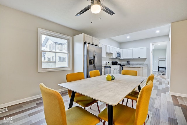 dining area featuring ceiling fan and light wood-type flooring