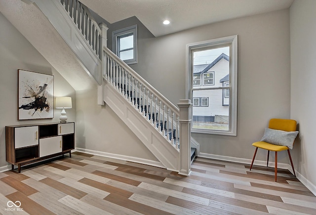 staircase featuring wood-type flooring