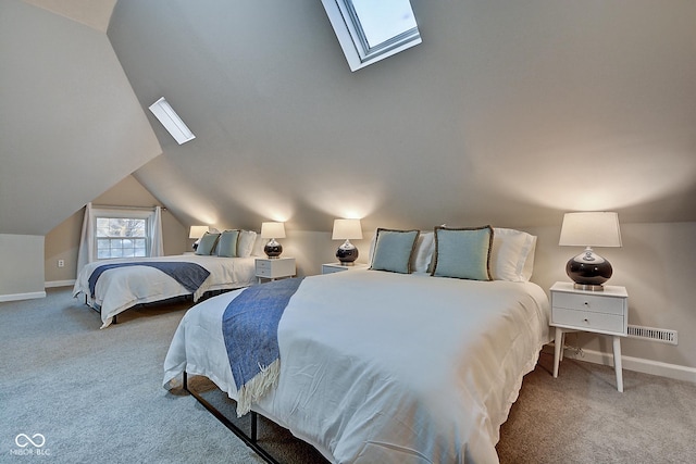 carpeted bedroom featuring vaulted ceiling with skylight