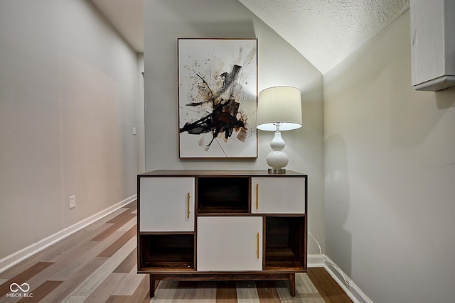 room details with hardwood / wood-style floors and a textured ceiling