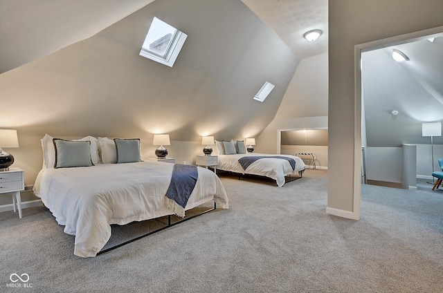 carpeted bedroom featuring lofted ceiling with skylight