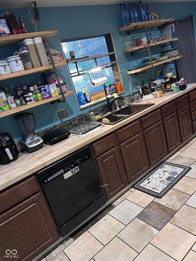 kitchen with light tile patterned flooring, dishwasher, sink, and dark brown cabinets