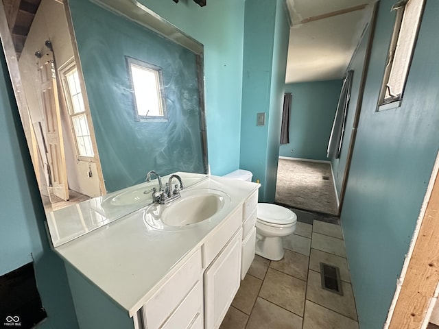 7903 Roseway Ct, Indianapolis, IN 46226 - half bathroom with tile patterned floors, visible vents, toilet, and vanity