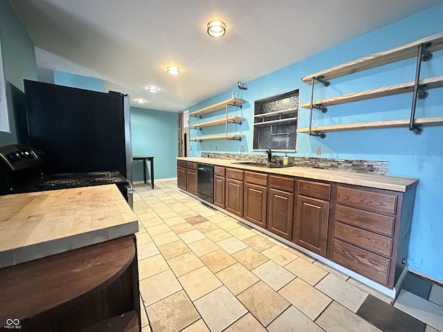 7903 Roseway Ct, Indianapolis, IN 46226 - kitchen featuring open shelves, baseboards, butcher block countertops, black appliances, and a sink