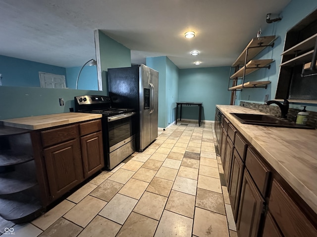 7903 Roseway Ct, Indianapolis, IN 46226 - kitchen with open shelves, stainless steel appliances, light tile patterned flooring, wooden counters, and dark brown cabinets