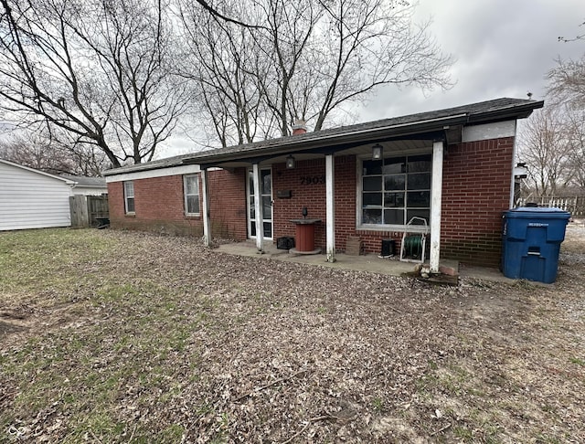 7903 Roseway Ct, Indianapolis, IN 46226 - back of property with brick siding, a patio area, a lawn, and fence