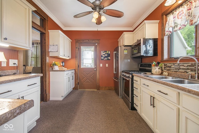 kitchen with sink, ornamental molding, stainless steel appliances, and ceiling fan