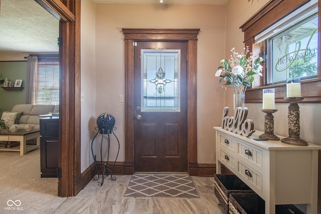 foyer with a textured ceiling