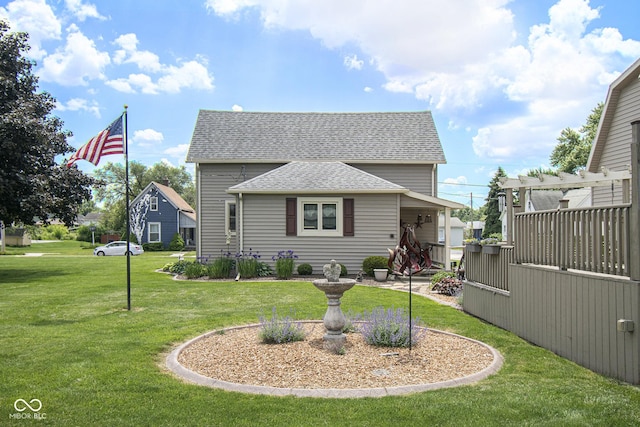 view of front of property with a pergola and a front lawn