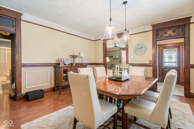 dining space featuring hardwood / wood-style floors and a textured ceiling