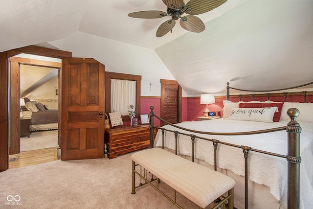 carpeted bedroom featuring vaulted ceiling and ceiling fan