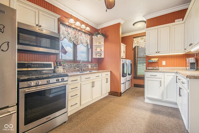 kitchen with white cabinetry, sink, a wealth of natural light, and appliances with stainless steel finishes