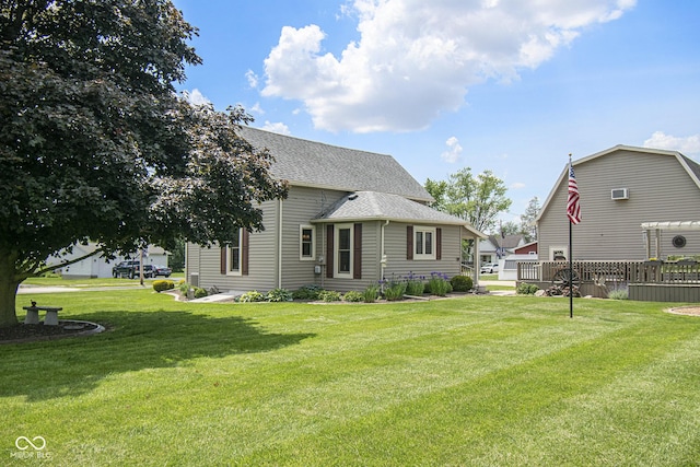 rear view of property featuring a lawn