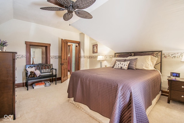 carpeted bedroom featuring ceiling fan and vaulted ceiling