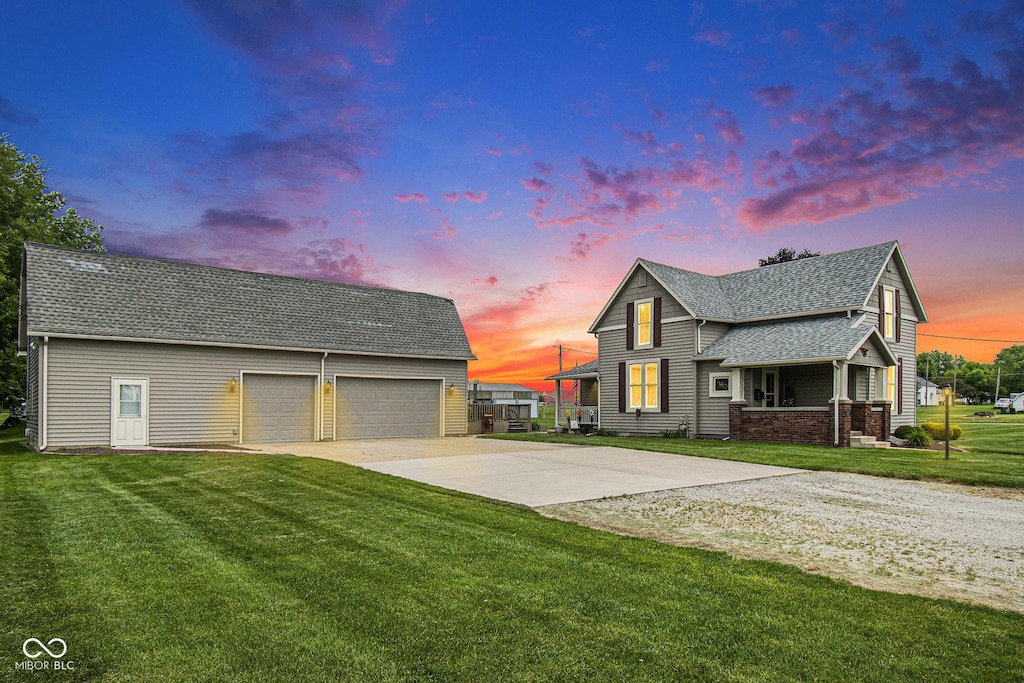 view of front of property featuring a yard and a garage