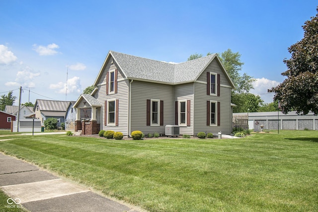 exterior space with a front yard and central AC unit