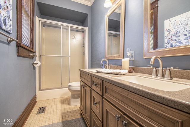 bathroom with a shower with shower door, vanity, toilet, crown molding, and tile patterned floors