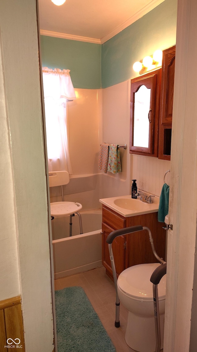 bathroom with vanity, a bath, crown molding, and toilet