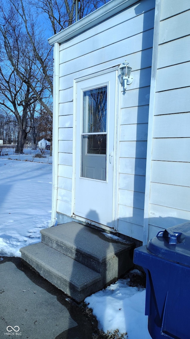 view of snow covered property entrance