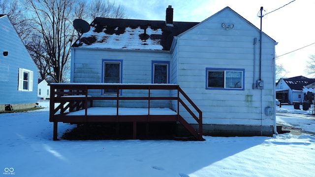 snow covered property featuring a wooden deck