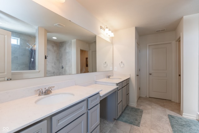 bathroom with vanity, tile patterned floors, and tiled shower