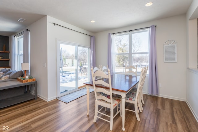 dining space with wood-type flooring