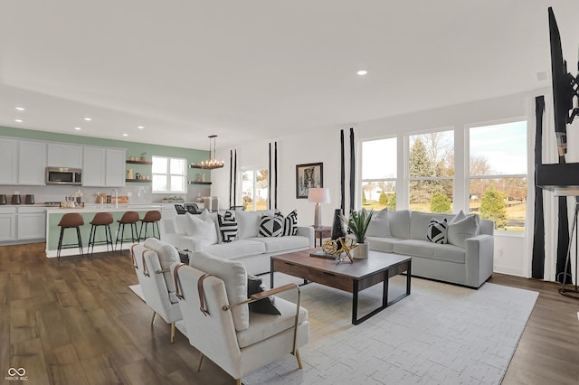 living room with sink, a wealth of natural light, and light hardwood / wood-style floors