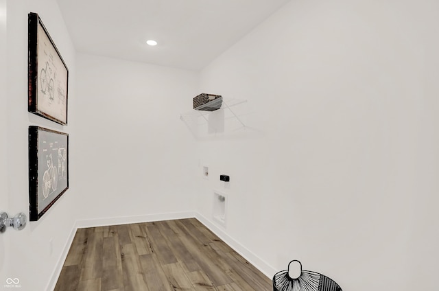 washroom with washer hookup, hookup for an electric dryer, and light hardwood / wood-style floors