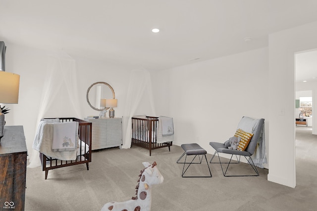 sitting room featuring light colored carpet