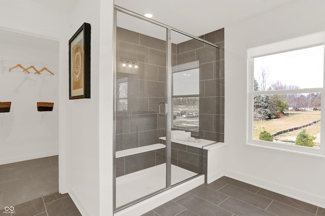 bathroom featuring an enclosed shower and tile patterned floors