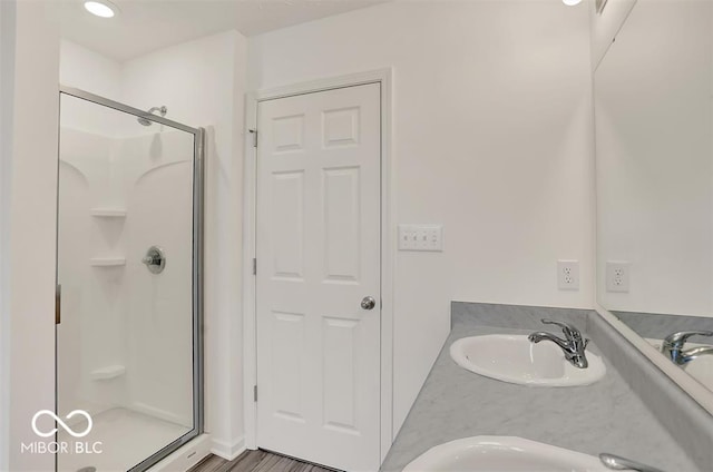 bathroom featuring an enclosed shower and vanity