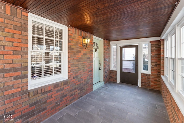 unfurnished sunroom featuring wooden ceiling