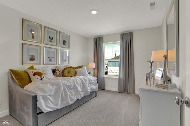 bedroom with light colored carpet