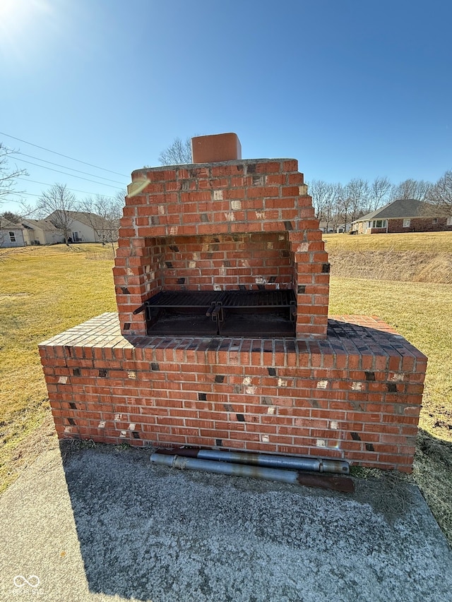 exterior details with an outdoor brick fireplace