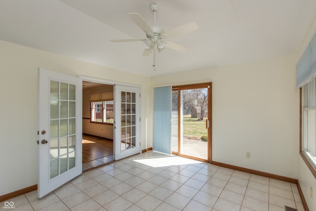 entryway featuring french doors, plenty of natural light, baseboards, and light tile patterned flooring