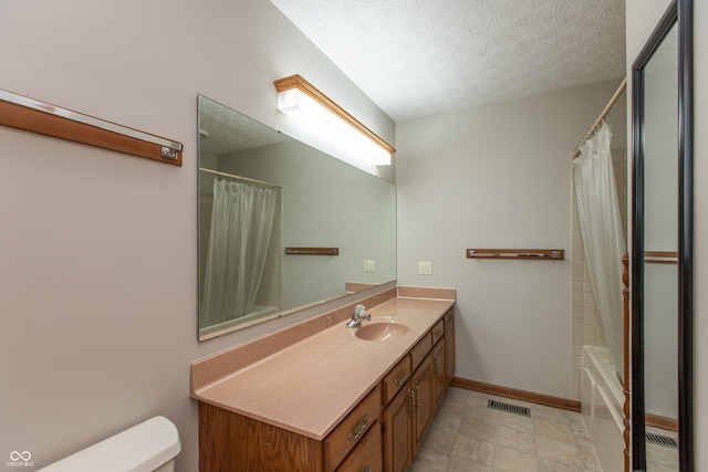 bathroom featuring visible vents, baseboards, toilet, vanity, and a textured ceiling