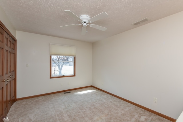 unfurnished bedroom featuring visible vents, light carpet, and baseboards