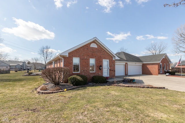 view of front of home with a garage, brick siding, concrete driveway, and a front yard