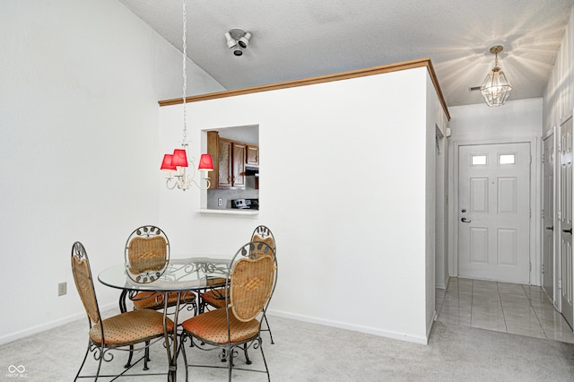 carpeted dining room featuring a textured ceiling