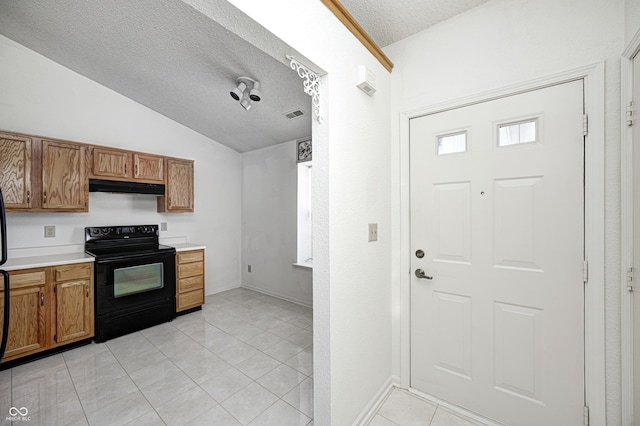 kitchen with black electric range oven, vaulted ceiling, light tile patterned floors, and a textured ceiling