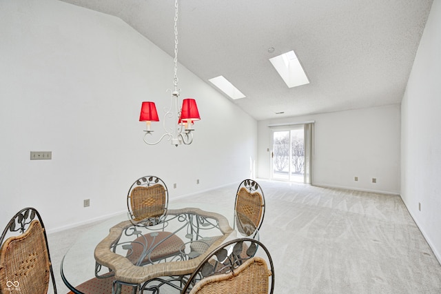 carpeted dining area with a textured ceiling and lofted ceiling with skylight