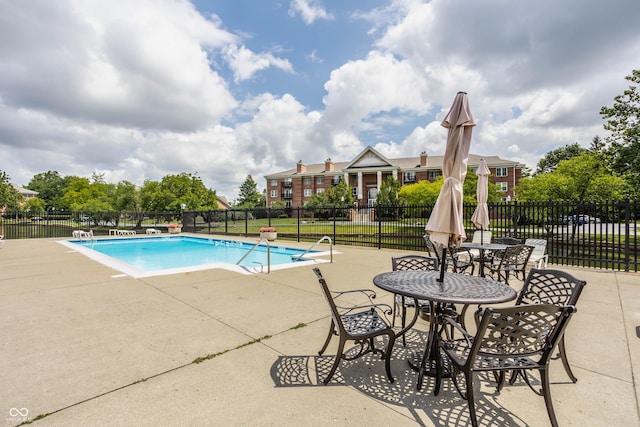 view of swimming pool with a patio area