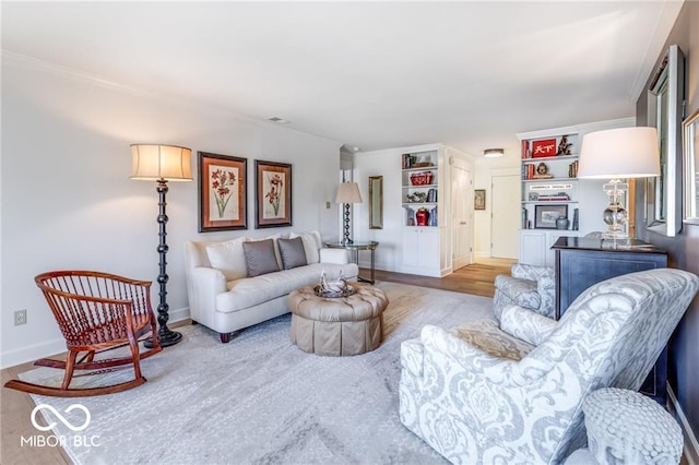 living room with crown molding and wood-type flooring