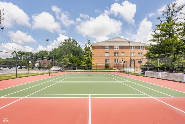 view of tennis court with basketball hoop