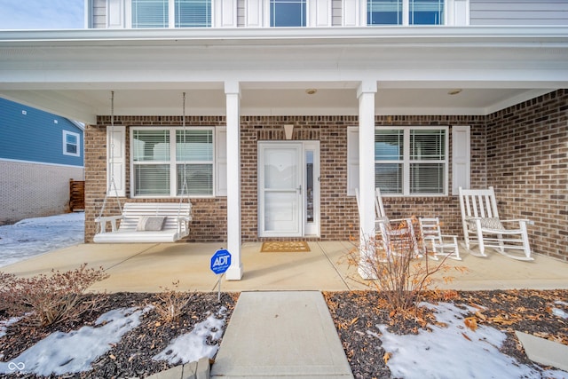 view of snow covered property entrance