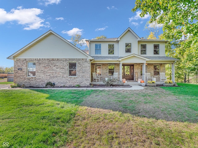 view of front of home with covered porch and a front yard